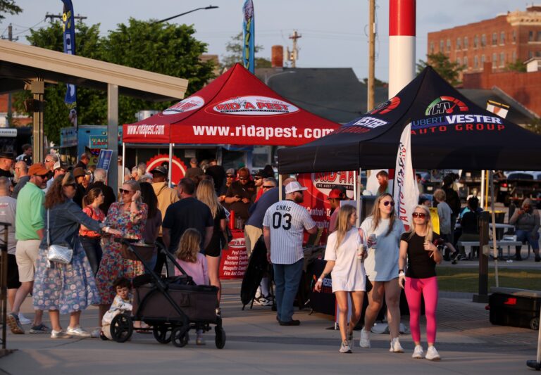 crowd at gig in the park concert with two sponsor tents in the background